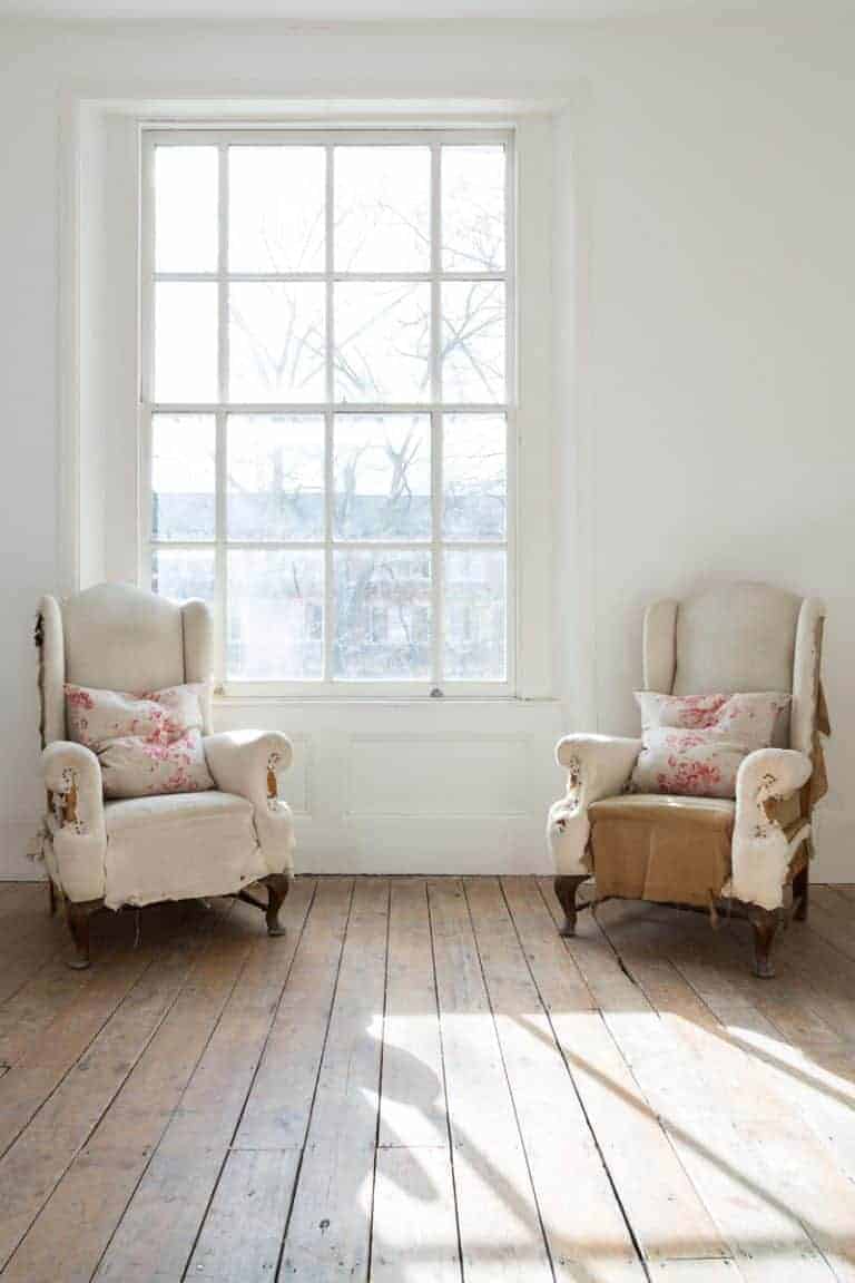 love these modern rustic distressed armchairs with pretty linen cushions by cabbages & roses