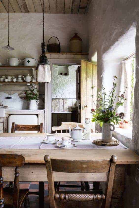 love this modern rustic country farmhouse kitchen dining room with reclaimed wooden cupboards, rustic wooden table, open shelves, rustic white-washed walls and tiled floor. Click through for more modern rustic farmhouse interiors ideas you'll love