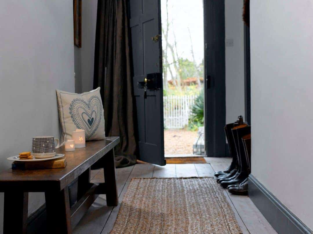 love this modern rustic hallway with dark grey farrow and ball door, stripped floor boards and rustic wood bench. Click through for more modern rustic country home ideas you'll love
