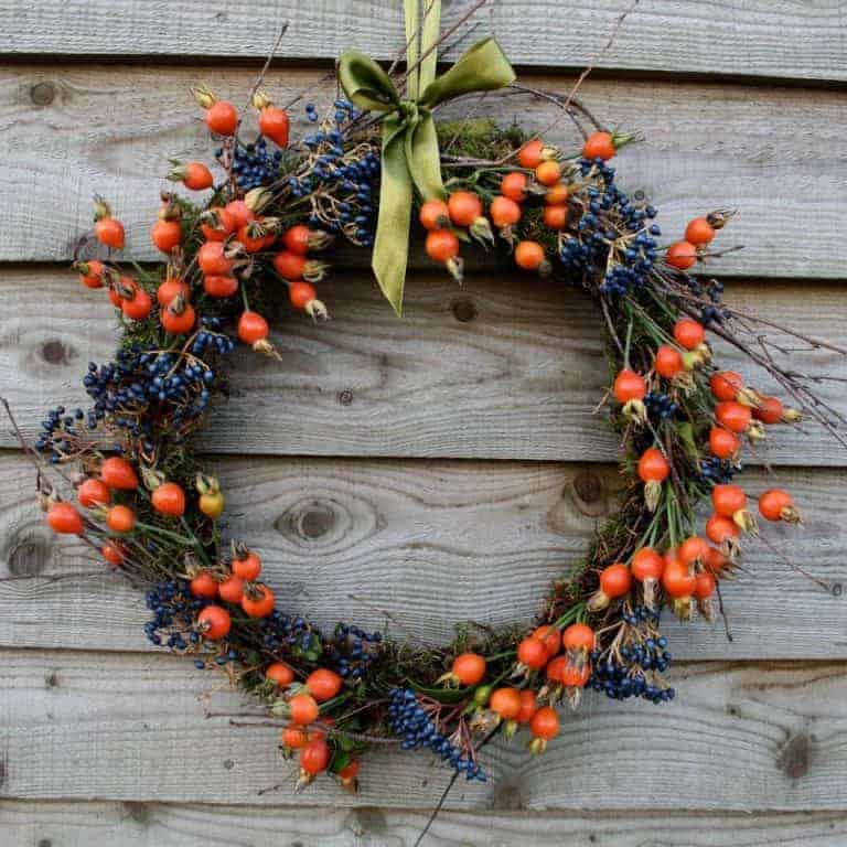 love this seasonal autumn wreath rosehips and viburnum berries. click through for more seasonal autumn flower arrangement ideas you'll love to make