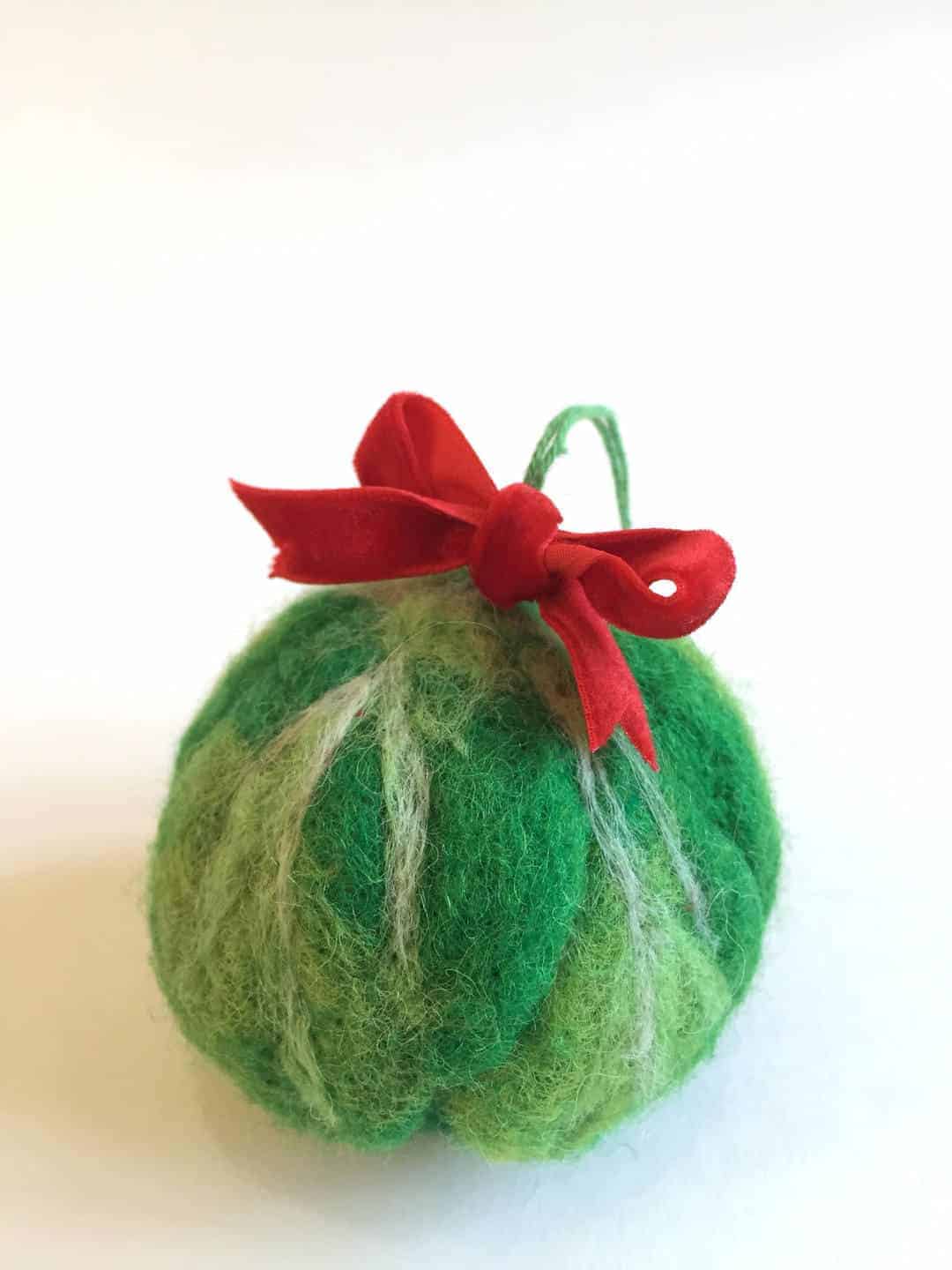 love this handmade wool felt brussels sprout christmas tree decoration by Emma Herian. Click through to find out more and to see other beautiful handmade christmas decorations we love