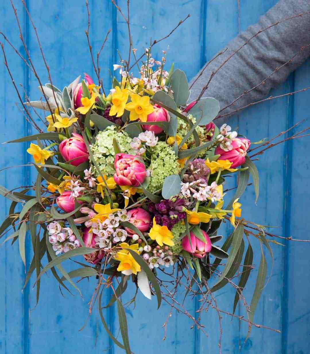 love this love these yellow, pink and white spring flowers by The Real Flower company - pink tullips, yellow daffodils, twigs, blossom and sage with fresh spring green eucaluptus. Click through for more beautiful spring flower arrangement ideas you'll love
