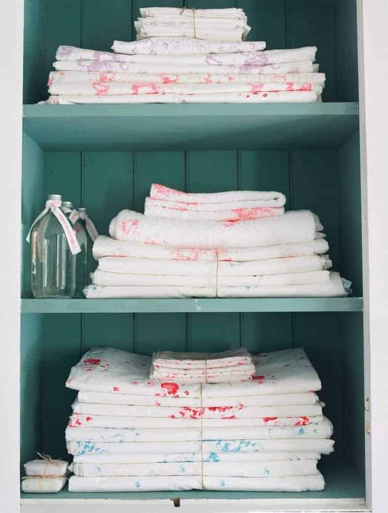 I dream of owning a vintage painted wooden cupboard or linen press stacked with linens like these faded floral fabrics by Cabbages & Roses. Click through for more ideas you'll love