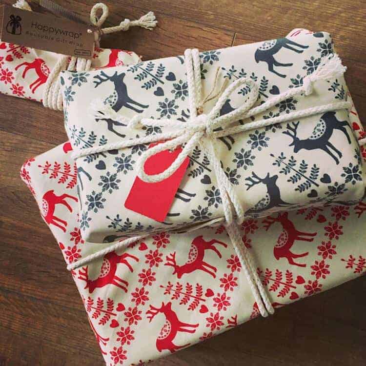 love this reusable gift wrap in fabric with reindeers in red or green. Can be used over and over and even thrown in the washing machine. Click through for more ethical eco-friendly and plastic free christmas gift wrapping ideas you'll love to try