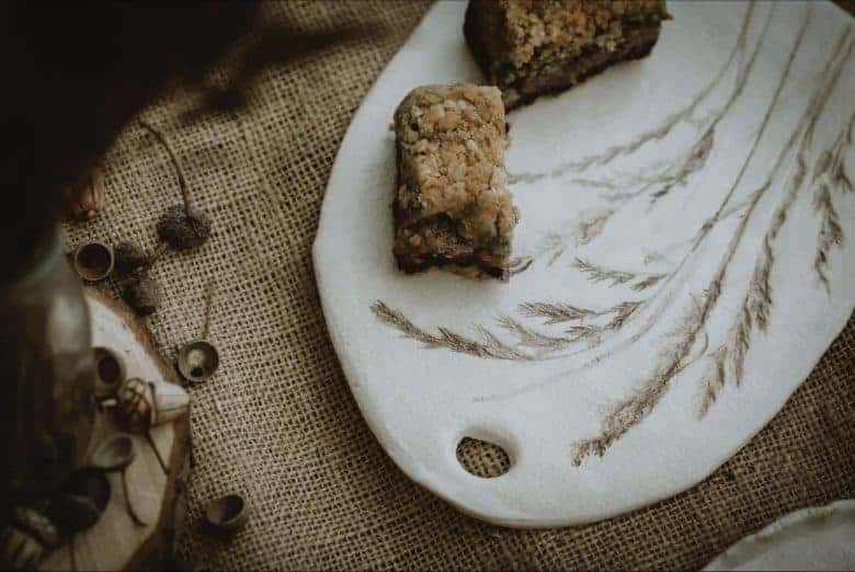 Meadow grass print stoneware ceramic platter by julie reilly for these two hands handcrafted in England with the imprint of wild grasses with ruffled edges and glazed with a cream-white and oxides to highlight the pattern in stoneware clay #meadow #grass #ceramic #platter #juliereilly #handmade