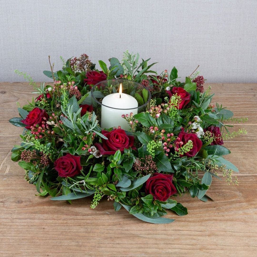 classic red rose and seasonal green foliage christmas centrepiece by the real flower company
