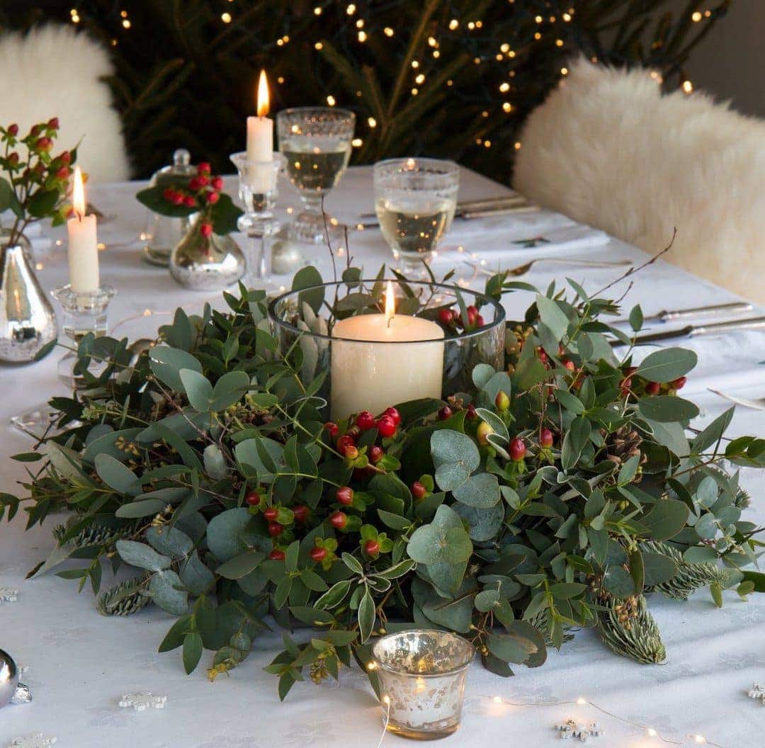 how to make a christmas centrepiece with fresh foraged festive greenery, holly, berries and foliage with expert step by steps and tutorial by the real flower company. Add a candle and you're good to go