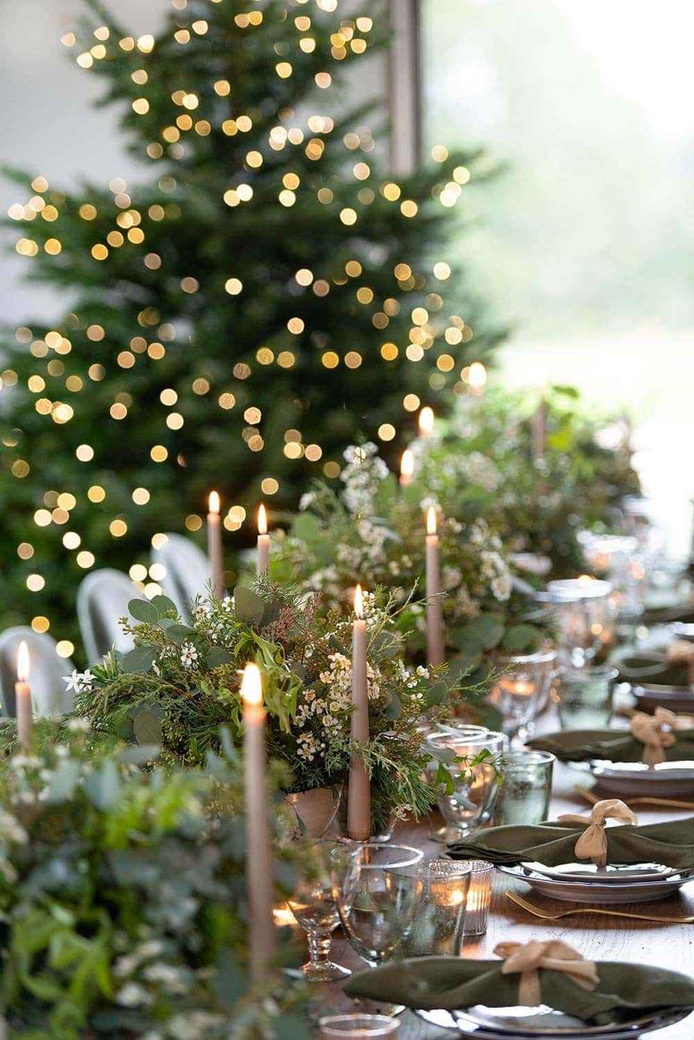 christmas centrepiece designed by phillippa craddock using seasonal evergreen foliage, aromatic herbs wax flowers, candles, tea light holders and 