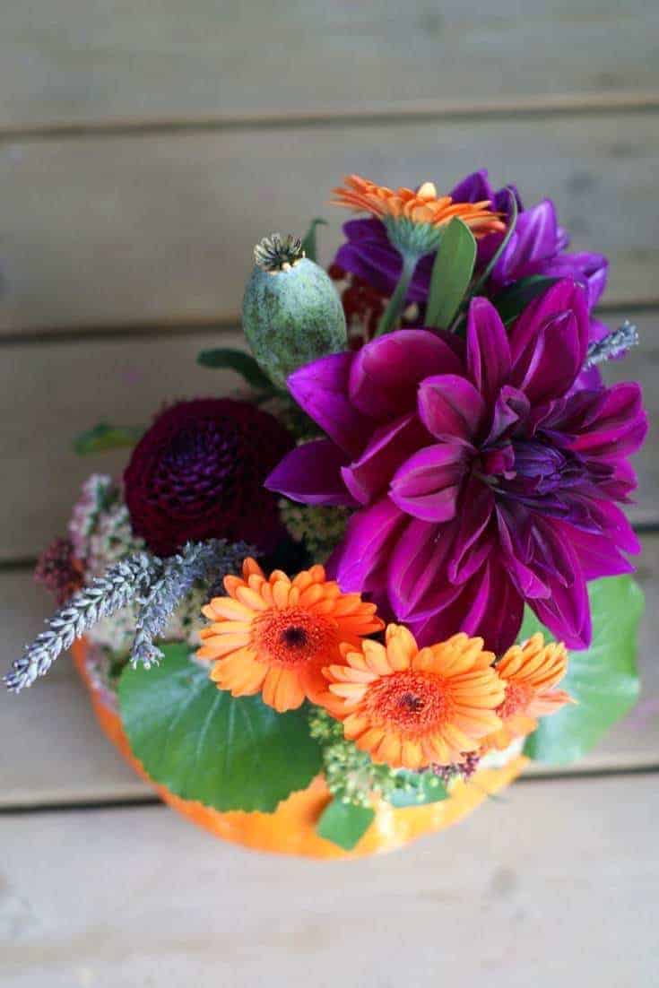 how to make an autumn halloween flower pumpkin decoration: how to arrange stunning autumn flowers with Sussex Flower School. Click through for inspiring autumn flower arrangement ideas you'll love