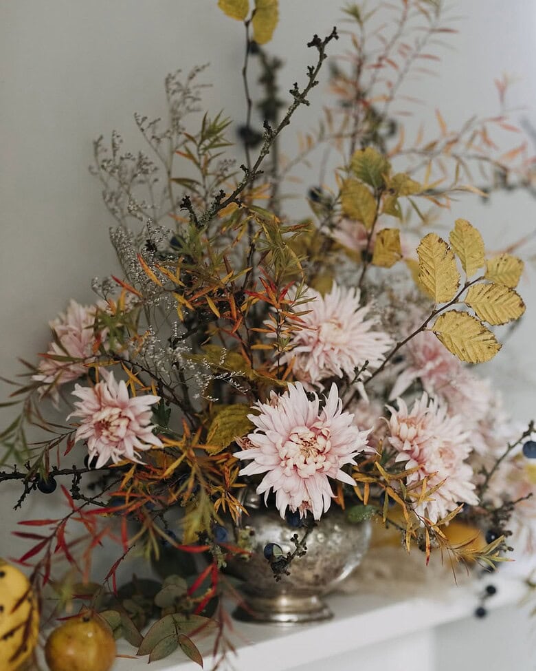 autumn flower arrangement by rachel siegfried of green and gorgeous flowers - creative design with chrysanthemums, seasonal foliage, lichen and a vintage burnished silver vessel.