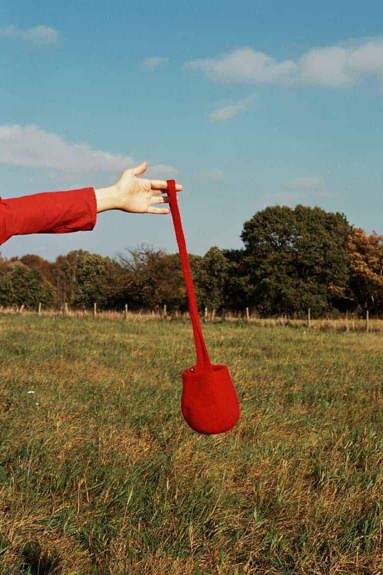 Cecilie Telle long strap red felt bucket bag