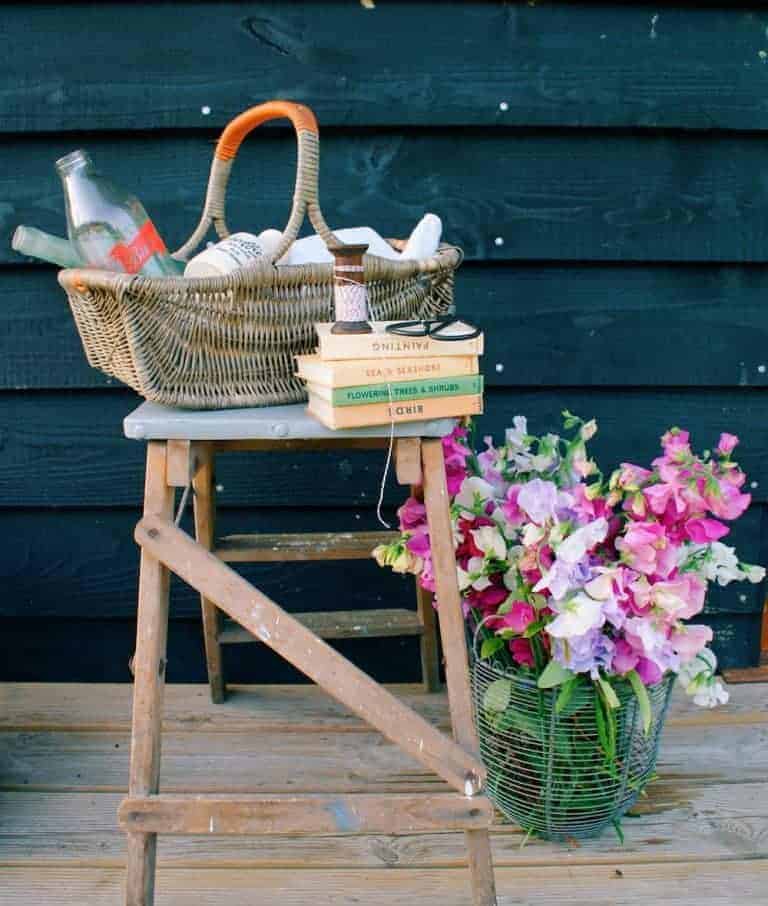 love this basket with sweet peas and vintage books at eco cabin tiny home on the isle of wight