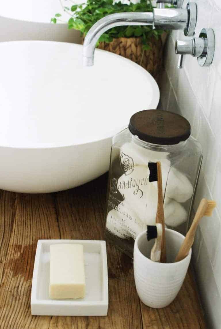 love this vintage soap jar and reclaimed wood stool. Click through for eco bathrrom ideas for plastic free and zero waste beauty you'll love