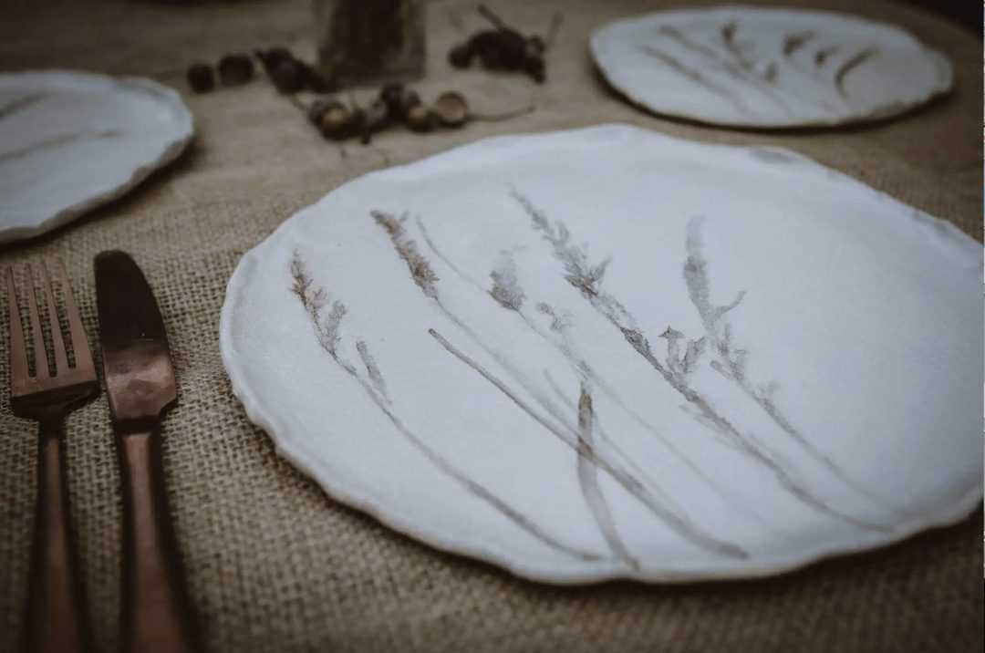meadow grass print ceramics by julie reilly for these to hands - handcrafted in England with the imprint of wild grasses with ruffled edges and glazed with a cream-white and oxides to highlight the pattern in stoneware clay #meadow #grass #ceramic #plate #juliereilly #handmade