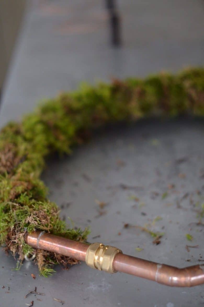 copper pipe base with moss giant christmas wreath
