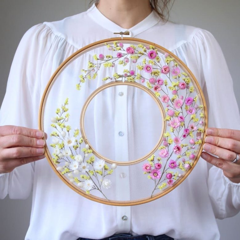 beautiful delicate spring dried flower embroidery on tulle hoop art in shades of pink yellow and white by olga prinku. Read my blog post to see loads more inspiring ideas by Olga, as well as her free DIY step by step tutorial to mastering this unique and beautiful creative craft as well as buy her kits