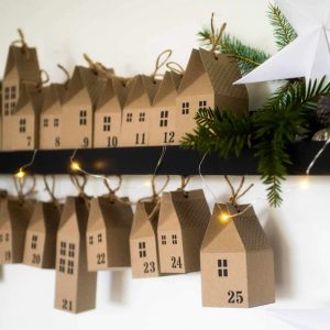 make your own diy advent calendar village little brown paper houses tied up with string