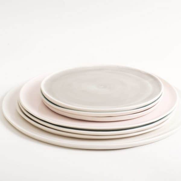 linda bloomfield handmade porcelain plates in pale pastel colours including pink, grey, blue, turquoise and white made in britain by Linda in her studio