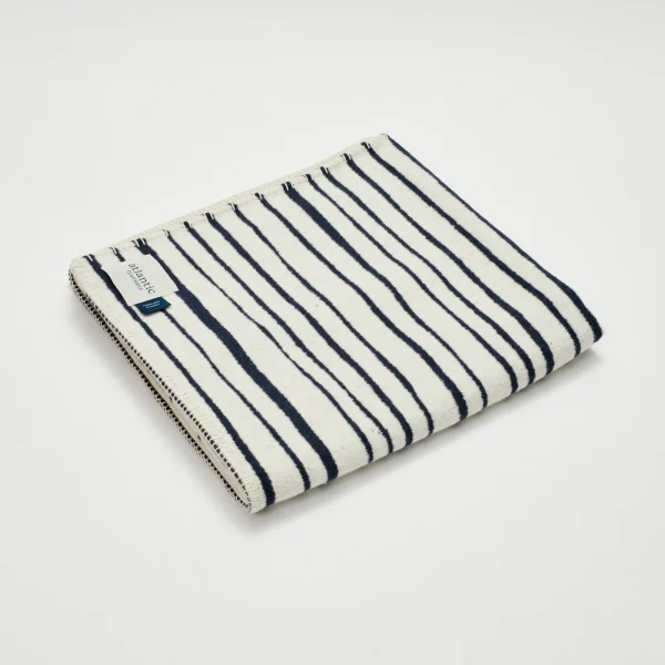 navy blue stripe recycled cotton blanket made in england by atlantic blankets with a smart organic navy and cream winter white stripe design