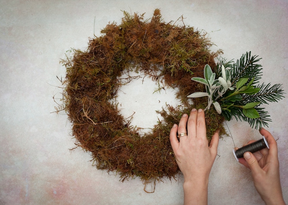 how to make a christmas centrepiece with fresh foraged festive greenery, holly, berries and foliage with expert step by steps and tutorial by the real flower company. Add a candle and you're good to go
