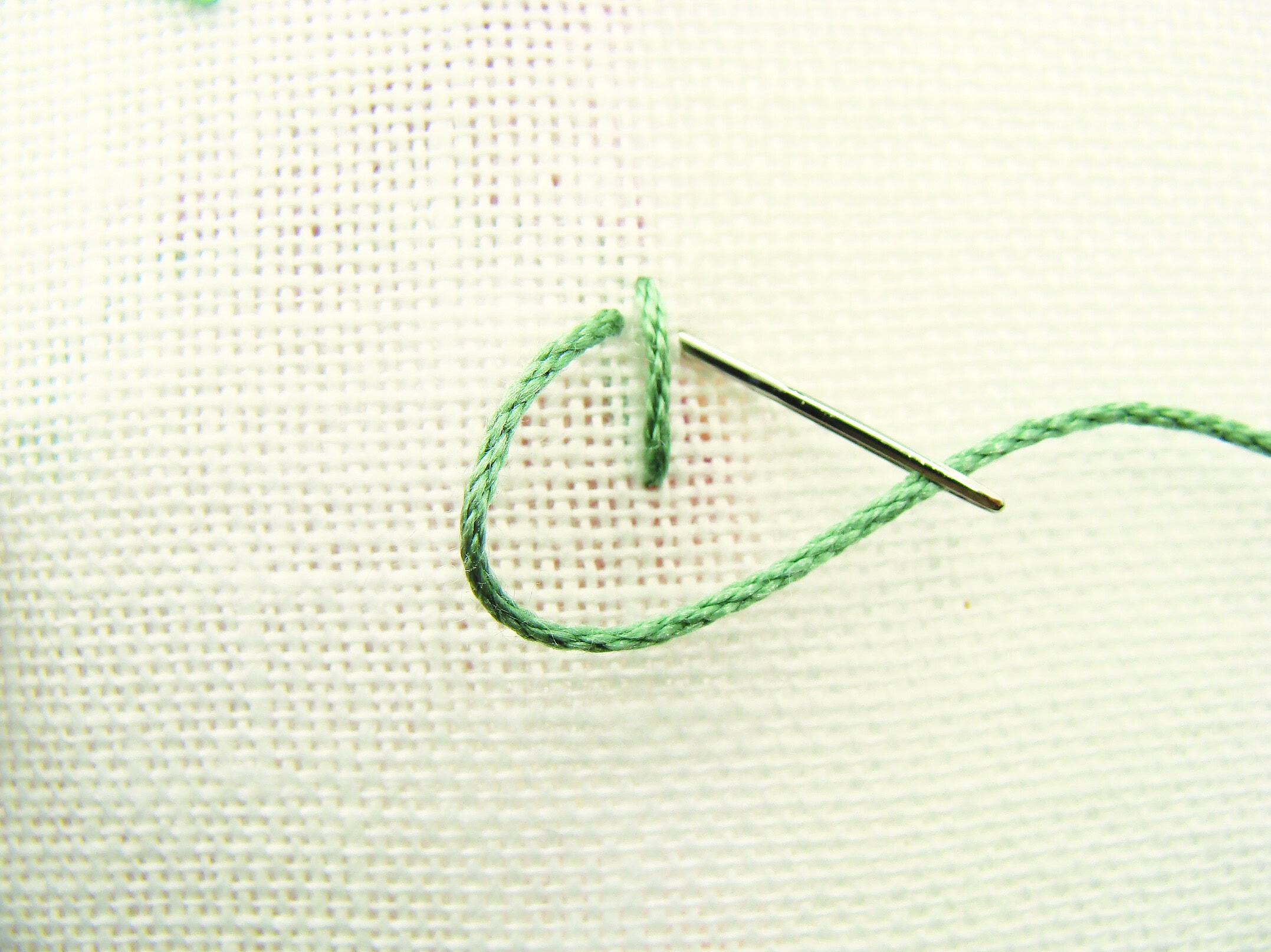 fly stitch step 1 make a straight stitch then add a loop around it